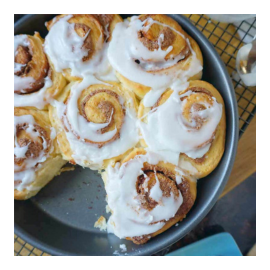 Cinnamon rolls with sweet cream frosting in a pan